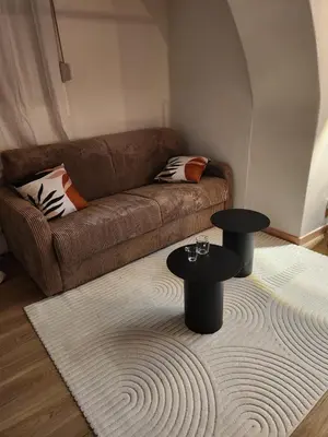 a living room with a couch and a table at Escapade sur la Sorgue in LʼIsle-sur-la-Sorgue