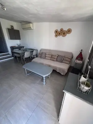 a living room with a couch and a table at Le pavé in Gordes