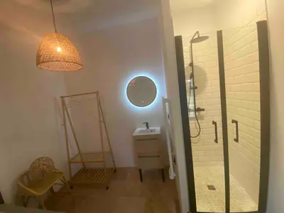 a bathroom with a shower and a sink and a light at Vacances face au Luberon in Robion en Luberon