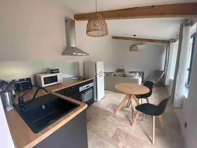 a small kitchen with a table and a microwave at Vacances face au Luberon in Robion en Luberon