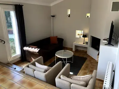 a living room with a couch and a table at La maison du bon remède in Mazan