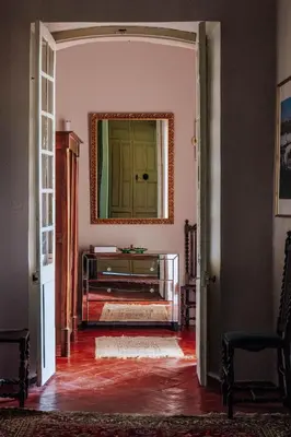 a hallway with a mirror and a dresser in a room at Chateau du Jonquier in Mazan