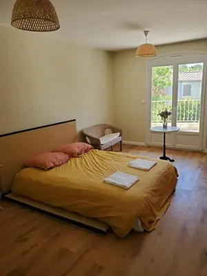 a bedroom with a large bed with two towels on it at Charming Famillial House with pedestrian access to Village in Venelles