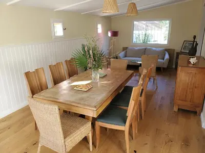 a dining room with a wooden table and chairs at Charming Famillial House with pedestrian access to Village in Venelles