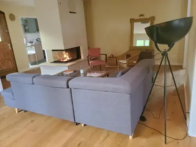 a living room with a gray couch and a camera at Charming Famillial House with pedestrian access to Village in Venelles