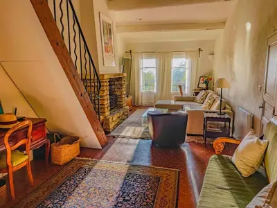 a living room with a couch and a fireplace at Maison de charme au coeur du village de Gordes in Gordes