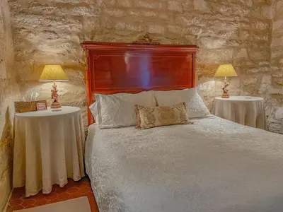 a bedroom with a bed with two tables and two lamps at Maison de charme au coeur du village de Gordes in Gordes