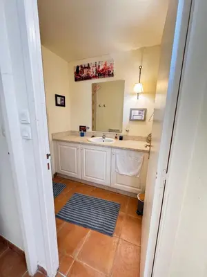 a bathroom with a sink and a mirror at Appartement au coeur du Golf de Saumane in Saumane-de-Vaucluse
