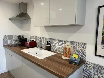 a kitchen counter with a white sink and a counter top at Chez Edouard - Superbe Triplex neuf - 6 chambres - Centre ville proche Rotonde allées provençales in Aix-en-Provence