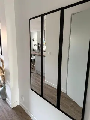 a mirror on the wall of a room with a kitchen at Chez Edouard - Superbe Triplex neuf - 6 chambres - Centre ville proche Rotonde allées provençales in Aix-en-Provence