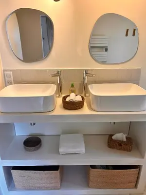 a bathroom with two sinks and a mirror at Mazet LEAJO 2 in Eygalières