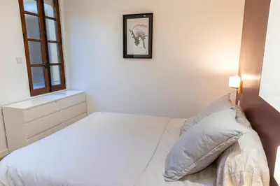 a white bedroom with a bed and a window at Appartement centre Aix Terrace et ascenseur in Aix-en-Provence