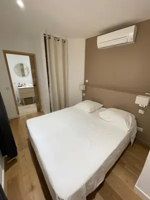 a bedroom with a white bed and a window at Appartement centre Aix Terrace et ascenseur in Aix-en-Provence