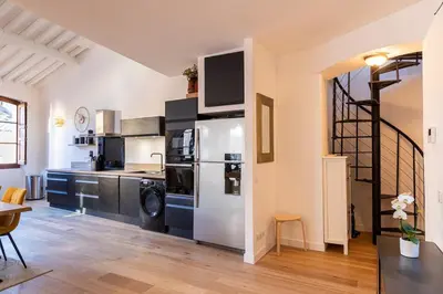 a kitchen with a stainless steel refrigerator and a stove at Appartement centre Aix Terrace et ascenseur in Aix-en-Provence