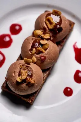 a white plate with three chocolate cookies with nuts at Camping 3 étoiles - Piscine - efaeh0 in Malemort-du-Comtat