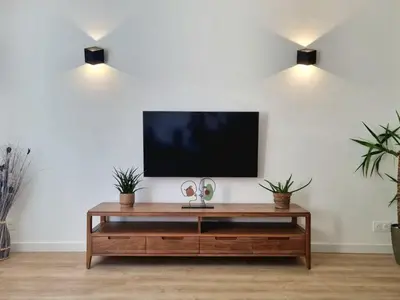 a living room with a tv on a white wall at Bright T2 - parking - AC in Aix-en-Provence