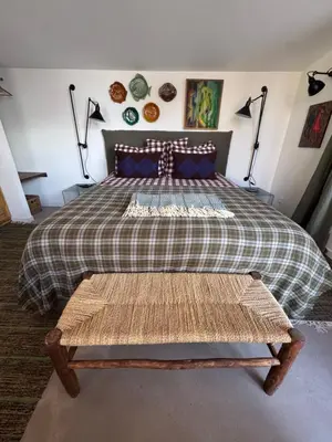 a bedroom with a bed with a plaid bedspread at CaBaNa 52 La chambre Proche Lourmarin in Cadenet