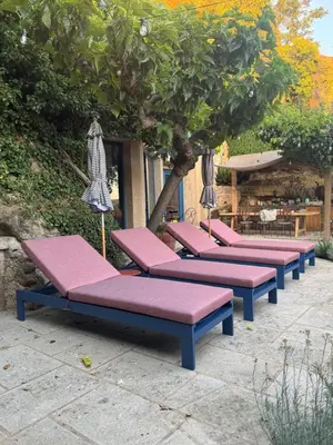a row of purple benches sitting under a tree at CaBaNa 52 La chambre Proche Lourmarin in Cadenet