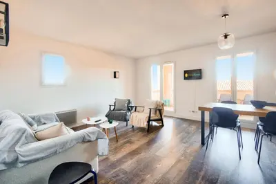a living room with a couch and a table at Les Coteaux de Pont Royal en Provence - maeva Home - Appartement climatisé 3 pièces 6 personnes - Prestige MAE-6331 in Mallemort