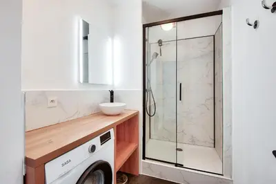 a bathroom with a shower and a washing machine at Les Coteaux de Pont Royal en Provence - maeva Home - Appartement climatisé 3 pièces 6 personnes - Prestige MAE-6331 in Mallemort