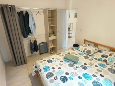 a bedroom with a bed with a comforter and pillows at Joli appartement Urbain in Cavaillon