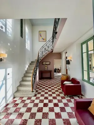 a room with a staircase with a checkered floor at Magnificent Bourgeois House Renovated with Elegance and Art Deco Style in Le Thor