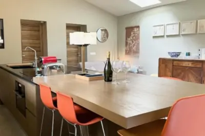 a kitchen with a table with a bottle of wine at Magnificent Bourgeois House Renovated with Elegance and Art Deco Style in Le Thor