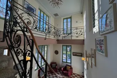 a staircase in a home with a wrought iron railing at Magnificent Bourgeois House Renovated with Elegance and Art Deco Style in Le Thor