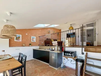a kitchen with a sink and a counter top at Duplex centre de Roussillon avec Climatisation et vue in Roussillon
