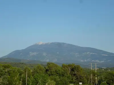 a mountain in the distance with trees in the foreground at Holiday Home in L'Isle-sur-la-Sorgue with Pool in LʼIsle-sur-la-Sorgue