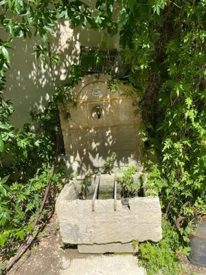 an old vase sitting on the side of a building at La Maison perchée - Mas de Rousseau in Eyragues