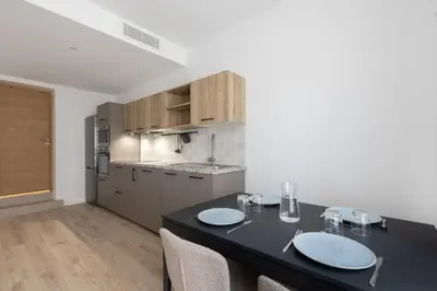 a kitchen with a table with two plates on it at Elégance en Luberon - 4 personnes - Central - Wifi in Apt