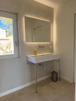 a bathroom with a white sink and a mirror at EcoLodge romantique proche Lourmarin Piscine Privée Borne recharge in Puyvert
