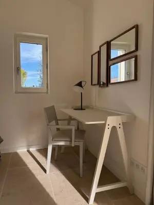 a white desk with a chair and a mirror at EcoLodge romantique proche Lourmarin Piscine Privée Borne recharge in Puyvert