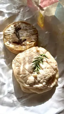 two pies sitting on a piece of wrinkled paper at La Bergerie Pradel in Le Beaucet