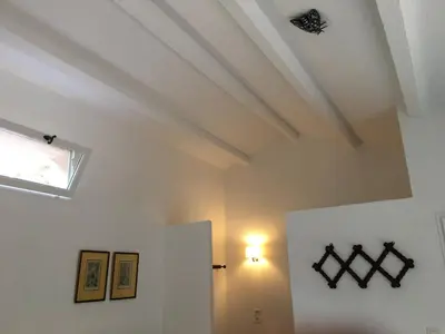 a room with white walls and a ceiling with a window at La Bergerie Pradel in Le Beaucet