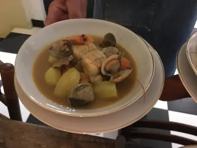a bowl of food with seafood and vegetables in it at La Bergerie Pradel in Le Beaucet