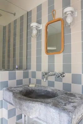 a bathroom with a marble sink and a mirror at Le charme au centre du village in Ménerbes