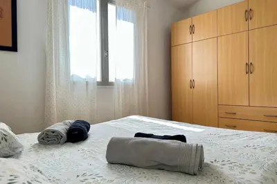 a bedroom with a bed with two towels on it at L'Isle en coeur air-conditioned house with garden and swimming pool in LʼIsle-sur-la-Sorgue
