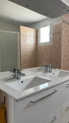 a bathroom with two sinks and a mirror at L'Isle en coeur air-conditioned house with garden and swimming pool in LʼIsle-sur-la-Sorgue