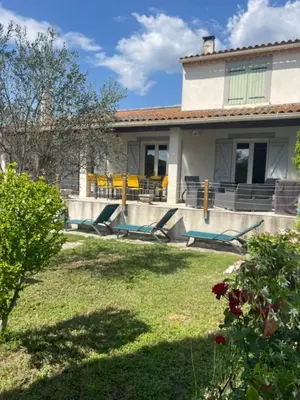 a house with a yard with chairs at L'Isle en coeur air-conditioned house with garden and swimming pool in LʼIsle-sur-la-Sorgue