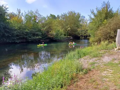 a group of people kayaking down a river at Maison au bord de l'eau in Le Thor