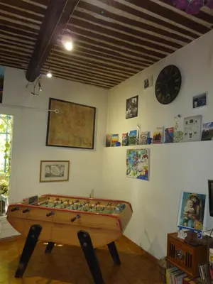 a room with a pool table and a clock on the wall at Gite Fa Mille maison bleu in Robion en Luberon