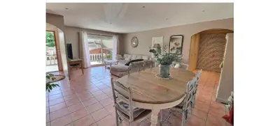 a dining room with a wooden table and chairs at Maison méditerranéenne 130m piscine Vaucluse in Carpentras