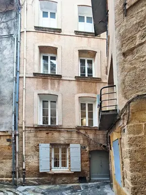 a brick building with white doors and windows at Le Solari - Studio lumineux au cœur du centre historique in Aix-en-Provence