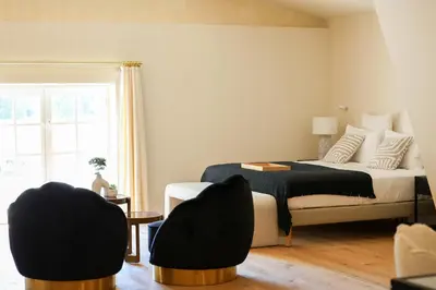 a bedroom with a bed and two chairs at Domaine Robert in Rognes