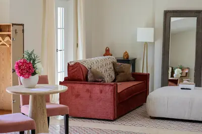 a living room with a red chair and a table at Domaine Robert in Rognes
