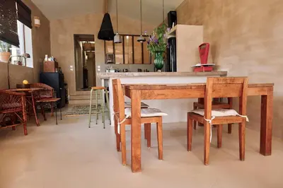 a dining room with a wooden table and chairs at Le Mas de Cink in Saint-Saturnin-les-Apt
