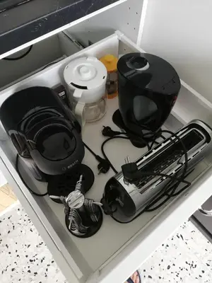 a drawer with a radio and other items in it at Gîte de la treille in LʼIsle-sur-la-Sorgue