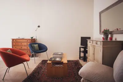 a living room with a couch and a table and chairs at Ancienne Maison des Gardes in Lourmarin